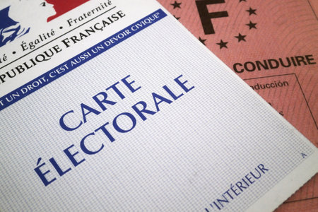 Paris, France - September 25 2016: Close up on an electoral voting card and a driver's license. In order to vote in France, one must bring his electoral card plus either a valid ID card, passport or driverâs license.のeditorial素材