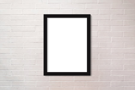 Full frame close up on a brick wall painted in white with a vertical picture frame with copy space.の写真素材