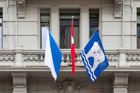 Flags of Zurich and Switzerland above a building entrance in the city center of Zurich.の写真素材