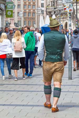 Munich, Germany - May 30 2019: Man in traditional clothing walking in the city center.のeditorial素材