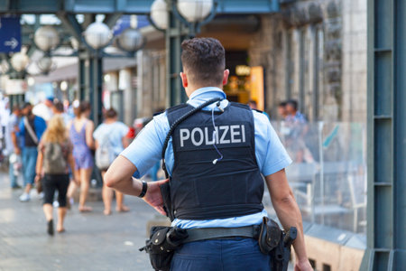 Hamburg, Germany - June 30 2019: Policeman in bulletproof vest patrolling outside of Hamburg Central Station.のeditorial素材