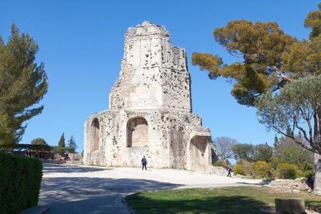 NÃ®mes, France - March 22 2019: The Magne tower (French: tour Magne) is a Gallo-Roman monument located in Nimes, Gard. More imposing vestige of the very long Roman enclosure of NÃ®mes, it dominates the gardens of the Fountain (French: jardins de la Fontaiのeditorial素材