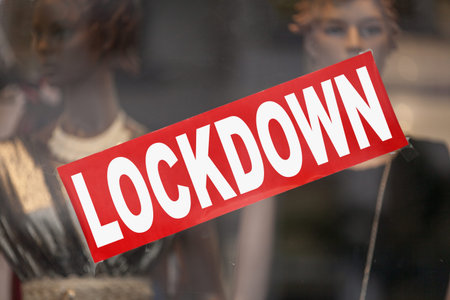 Red sign in a window shop saying in Lockdown.