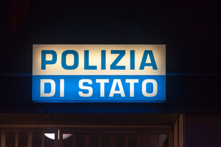 Genoa, Italy - March 30 2019: Illuminated sign above the entrance door of a police station stating "Polizia di stato" (English: State Police).のeditorial素材