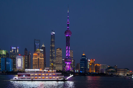 Shanghai, China - August 10 2018: Financial district of Pudong at dusk including some wellknown skyscraper: The Shanghai Tower, the Huangpu River, the Shanghai World Financial Center, the Jin Mao Tower and the Oriental Pearl Tower which is an antenna.のeditorial素材