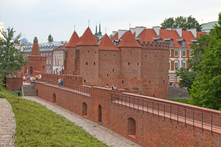 Warsaw, Poland - June 08 2019: The Warsaw Barbican (Polish: Barbakan Warszawski) is a 16th-century castle defense wall with towers. It was reconstructed in the mid-20th century.のeditorial素材