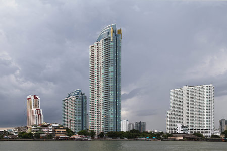 Modern condominiums and other buildings alongside the Chao Phraya river in Bangkok, Thailand. The...