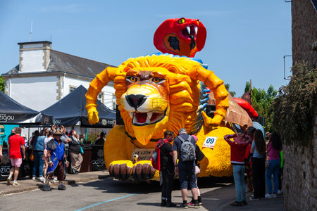 ScaÃ«r, France - May 29 2023: Lion and cobra themed float of the Carnaval Ã  l'ouest. The carnival takes place every two years (odd years) during the Pentecost weekend.のeditorial素材