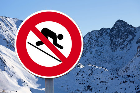 Round forbidden sign with with a man skiing symbol drawn in the middle.の写真素材