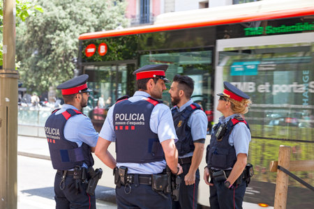 Barcelona, Spain - June 08 2018: Four police officers from the Mossos d'esquadra (Squad cops)...