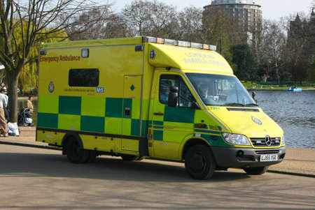 London, England - April 06 2007: London Ambulance parked by the Serpentine in Hyde Park where people like to do activities such as rollerblading or skateboarding. Because these activities are subject to frequent accidents, there is always an NHS ambulanceのeditorial素材