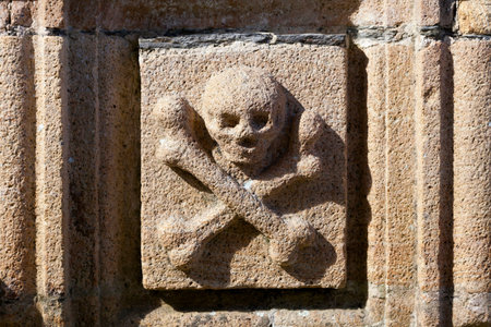 Skull and bones sculpted on the ossuary of the Saint-Yves church in La Roche-Maurice.