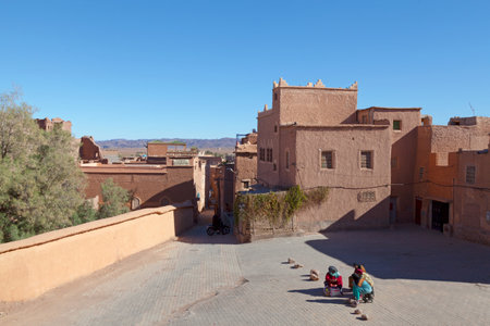 Ouarzazate, Morocco - January 30 2019: Berber women chating in Rue de la MosquÃ©e (English: Street of the Mosque) inside of the Kasbah Taourirt.のeditorial素材