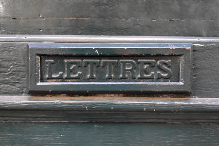 Close-up on a mail slot with written in French "Lettres", meaning "Letters" in English.の写真素材