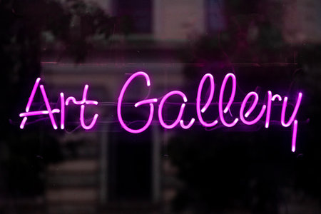 Close-up on a purple neon light shaped into a the phrase "Art gallery".の写真素材