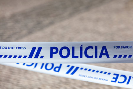 Police tape with written in it in Portuguese "PolÃ­cia" meaning "Police" in English.の写真素材
