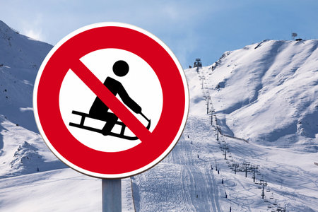 Forbidden sign with with a man on a sled symbol drawn in the middle.の写真素材
