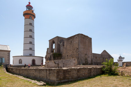 Plougonvelin, France - July 24 2017: The pointe Saint-Mathieu with its lighthouse and the abbey ruins. It is located near Le Conquet in the territory of the commune of Plougonvelin in France, flanked by 20m high cliffs.のeditorial素材