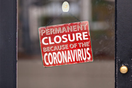 Red closed sign with written in it Permanent closure because of the coronavirus.