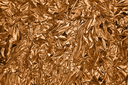 Fullframe crumpled copper foil shining texture background.