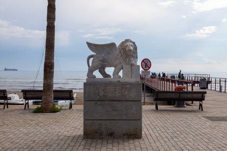 Larnaca, Cyprus - February 17 2024: The Winged Lion of Venice Statue (Lion of Saint Mark) at the end of Finikoudes promenade in front of the pier at the square of the Medieval Castle. It is a gift to Larnaka from Venice as a token of Larnakaâs twinning のeditorial素材
