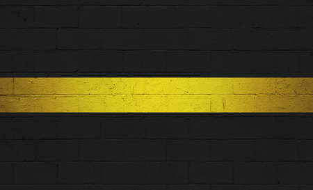 American Dispatcher Thin Gold Line painted on a cinder block wall.の写真素材