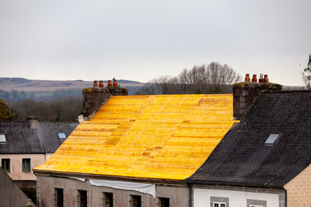 Replacing a slate roof of a small house in the Monts d'ArrÃ©e in Brittany.の写真素材