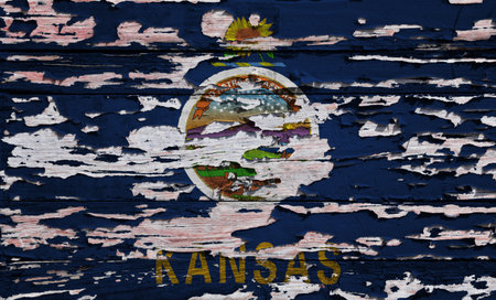 Flag of Kansas painted on a grunge wooden board.の写真素材