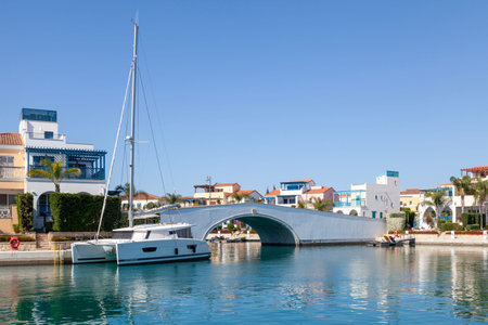 Limassol, Cyprus - May 05 2025: Catamaran moored at the bridge connecting the Island Villas to Limassol Marina.のeditorial素材