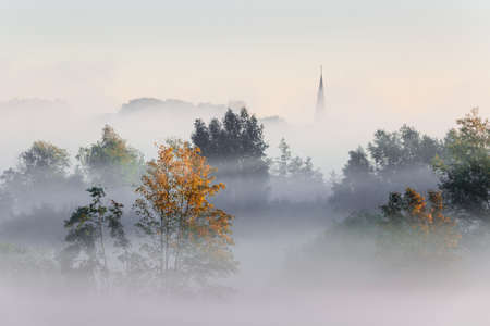 a sureal misty landscape in Flanders with a view towards the church of Tielrode.の写真素材