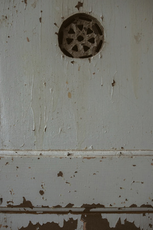 Old wooden rustic grey door texture in beautiful studio, close up of peeling paintの写真素材