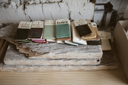 Colored glazed ceramic samples on old wood in workroomの写真素材
