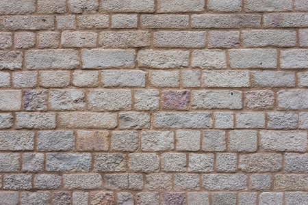 Texture of ancient stone sand colored wallの写真素材