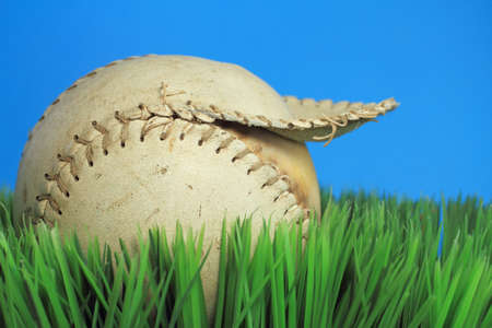 Tattered Baseball  An ols torn baseball on artificial turf の写真素材