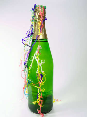 Photo of a bottle of champagne with confetti streamsの写真素材
