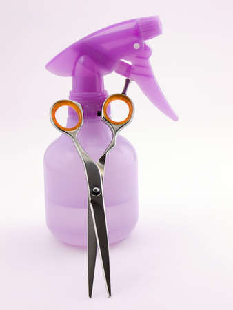 Photo of a spray bottle and hair cutting shears. Clipping path includedの写真素材