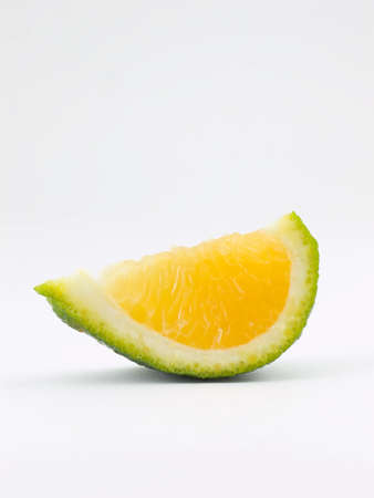 Photo of a slice of a tangeloの写真素材