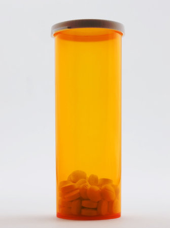Photo of a bottle pills standing on its end