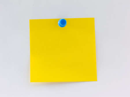 Blank yellow note pinned to a wallの写真素材
