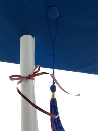 Graduation cap, tassel, and diploma isolated on whiteの写真素材