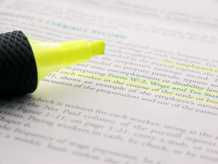Highlighted text in a book, with a highlighter on topの写真素材