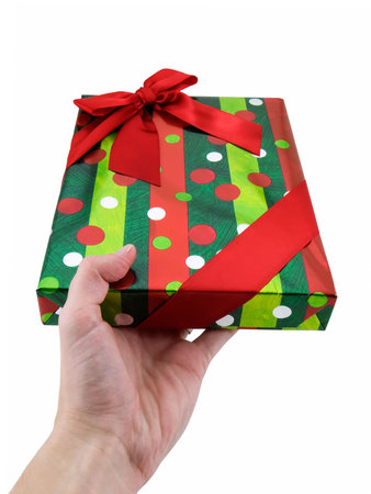 Hand holding out a christmas present, isolated on white
