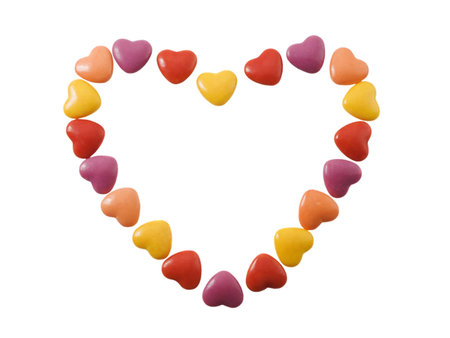 Heart shape made of small candy hearts isolated on white