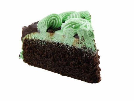Slice of mint chocolate cake isolated on whiteの写真素材