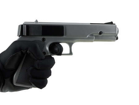 Gloved hand holding a handgun, isolated on whiteの写真素材