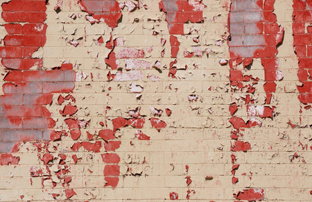 Painted brick wall with some of the paint peeling offの写真素材