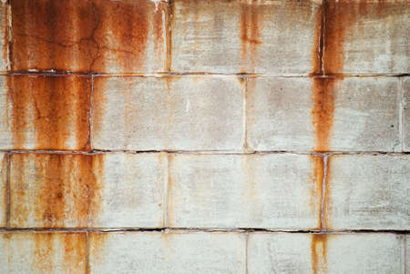 Weathered brick wall with rust stains の写真素材