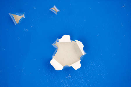 Blue paint peeling away from cementの写真素材