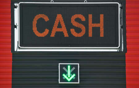 Cash sign with an arrow pointing downの写真素材