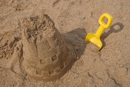 Sand castle and shovel in the sand